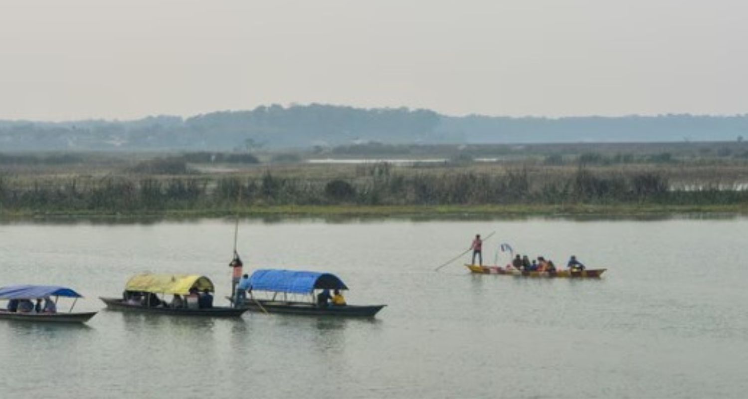 Tourists enjoy a boat ride at the Teesta river in Jalpaiguri district